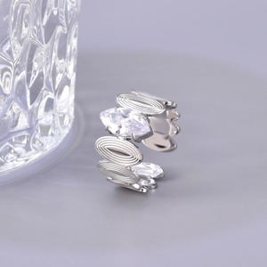 Macro shot of silver titanium steel ring featuring marquise zircon and ripple band design