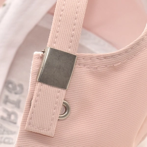 Detail of pink cotton baseball cap featuring an adjustable strap with matte metal buckle