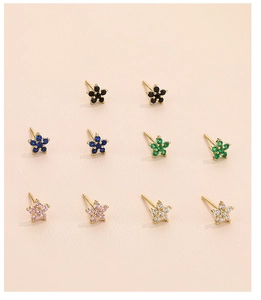 Close-up of five-petal earrings set with colorful zircon stones in gold plating