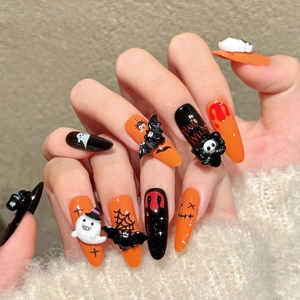Halloween press-on nails featuring 3D ghost, bat, and skull designs in orange and black