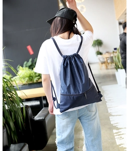 Rear view of a navy blue waterproof nylon drawstring backpack with a hidden zipper pocket