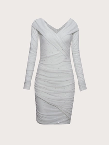 Detail of white sequined dress showing delicate ruched texture and shimmering mesh fabric
