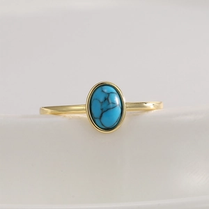 Bohemian gold ring featuring an oval turquoise stone with natural marble textures