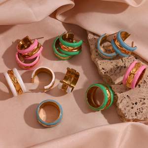 Detailed macro of 18K gold plated water wave rings and earrings with colorful enamel oil