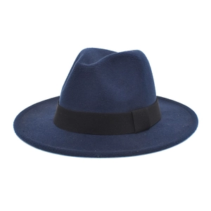 Close-up of the black elastic band detail on a navy blue wool felt fedora hat