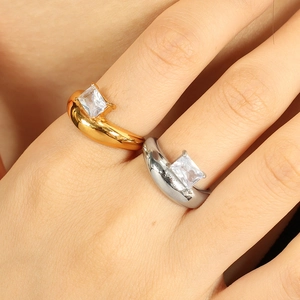 Minimalist irregular rings in gold and silver finish with square zircon stones worn by model