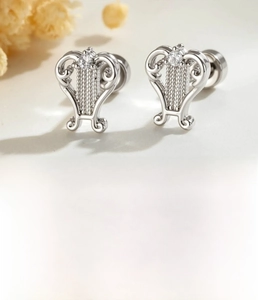 Macro shot of silver accordion style ear stud with zircon inlay and flat screw back