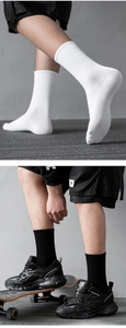 Detailed texture of white and black ribbed mid-calf cotton sports socks for streetwear