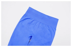 Close-up of seamless ribbed high waistband on royal blue yoga pants with knit texture