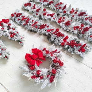 Detailed set of flocked Christmas wreaths and garlands with red bows and pine cones