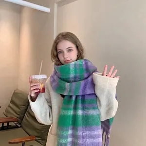 Lifestyle shot of soft mohair plaid scarf in purple and green with long fringe detail