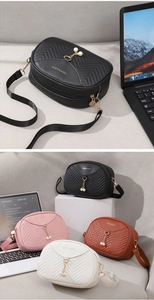 Close-up of shell bags with V-shaped quilting, pearl pendants and fashion lettering