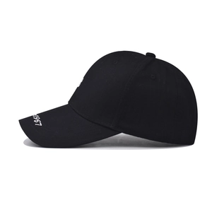 Detail of black cotton baseball cap showing white 1967 embroidery and fabric texture