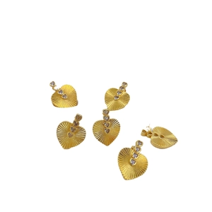 Golden vintage heart earrings with radial textures and sparkling zircon accents