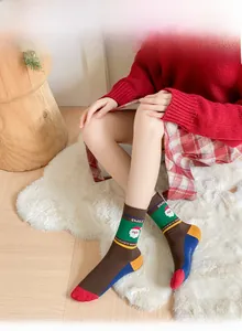 Close-up of Santa Claus pattern cotton socks with vibrant contrast heel and toe details