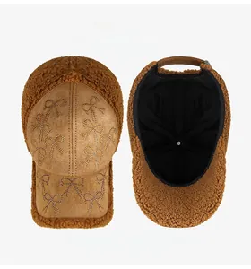Detailed front view of plush baseball cap with rhinestone bow and velvet suede brim