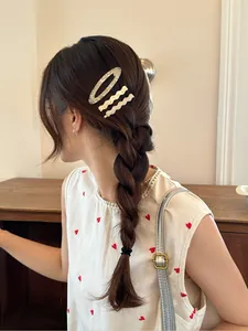Acetate hair clip set with marble grey and ivory wave pins worn on a braided hairstyle