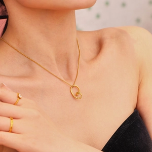Minimalist 18k gold plated hollow heart necklace and ring set on female model