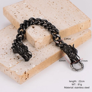 Retro stainless steel Viking dragon head Cuban link bracelet on stone background