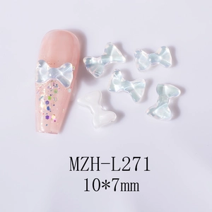 Detail view of 10x7mm aurora ribbon nail charms with iridescent crystal finish on nails