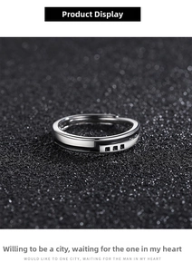Detail of silver open ring with black enamel stripes and square black zircons