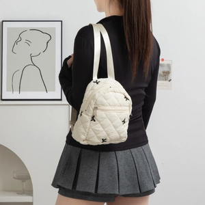 Quilted off-white mini backpack with butterfly embroidery and diamond pattern