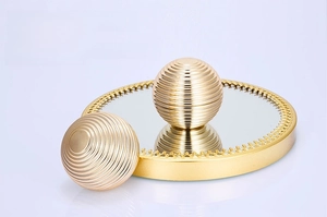 Detailed macro view of golden cosmetic cream jar lid with horizontal ring texture and mirror reflection