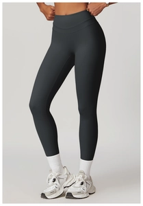 Detail view of high-waisted charcoal grey yoga leggings with elastic matte finish fabric