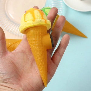 Realistic yellow ice cream cone fridge magnet with orange drizzle and colorful sprinkles