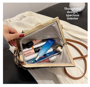 Detail view of the leopard print shell bag internal storage and smooth metal zipper