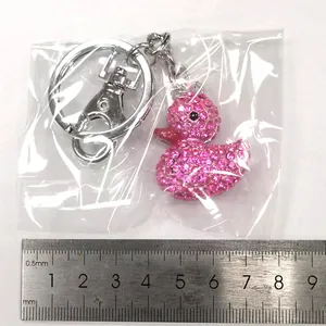 Close-up of pink crystal duck keychain with measurements and sparkling rhinestones