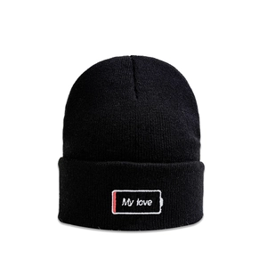 Detailed close-up of My Love embroidery on black ribbed knit beanie with low battery icon