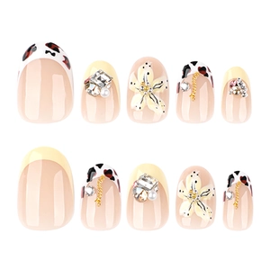 Short round press-on nails with 3D flowers, leopard print, and rhinestone accents