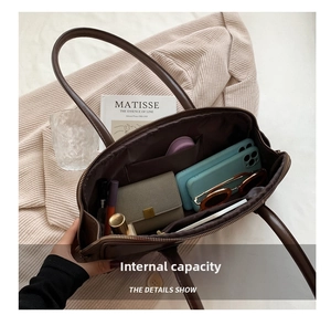 Internal capacity of large brown leather shoulder bag with phone and wallet inside