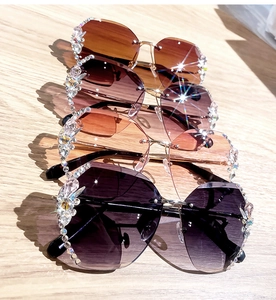 Detail of rimless sunglasses with rhinestone-encrusted lenses in multiple colors