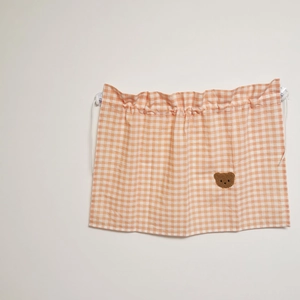 Detail of orange plaid car sunshade with cute bear embroidery and suction cups