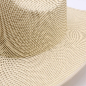 Close-up of fine woven texture and detailed brim on light beige straw cowboy hat