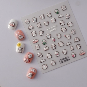 Macro detail of 5D embossed nail stickers featuring white chubby rabbit cartoon designs
