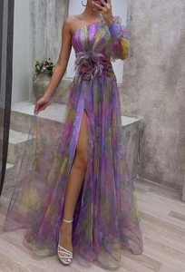 Detail of floral appliques and sheer mesh texture on this one-shoulder slit maxi dress