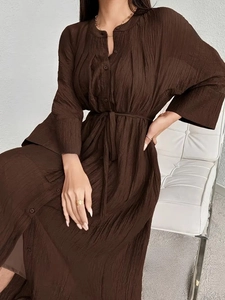 Elegant brown pleated maxi dress with v-neck, batwing sleeves and matching waist belt