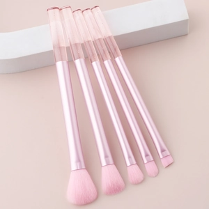 Detailed view of 5-piece mini makeup brushes with glitter crystal handles and pink bristles