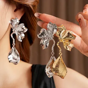 Chic metallic flower earrings with layered petals and large teardrop pendants in gold finish