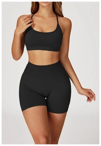 Detail of seamless black high-waisted yoga set with ribbed waistband and sports bra