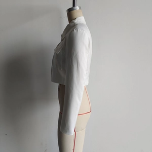 Side view of white cropped blazer jacket on mannequin showing sharp tailored silhouette