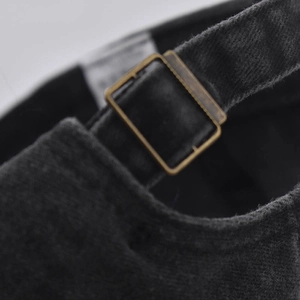 Detail of the vintage washed cotton baseball cap with a brass metal adjustable buckle