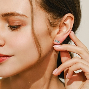 Elegant 925 sterling silver infinity stud earrings with turquoise stones on model