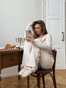 Women's two-piece floral long sleeve pajama set in cream knit with red flower patterns