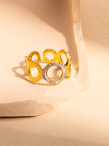 Detailed view of gold plated hollow circle ring with pavé set zircon stones on stone stand