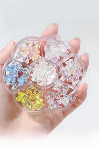 Detailed view of aurora nail art set with resin bears bows and pearls in a clear tray