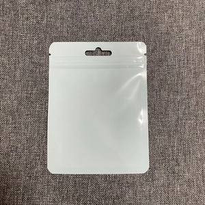 Close-up of a white premium resealable packaging bag with hanging hole and secure zip seal